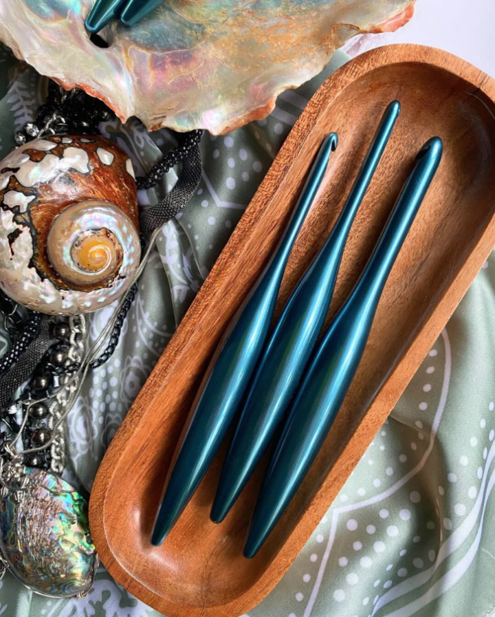 Venture & Tempest: A Furls Crochet Giveaway! This is a picture of 3 crochet hooks laying in a wooden bowl. 