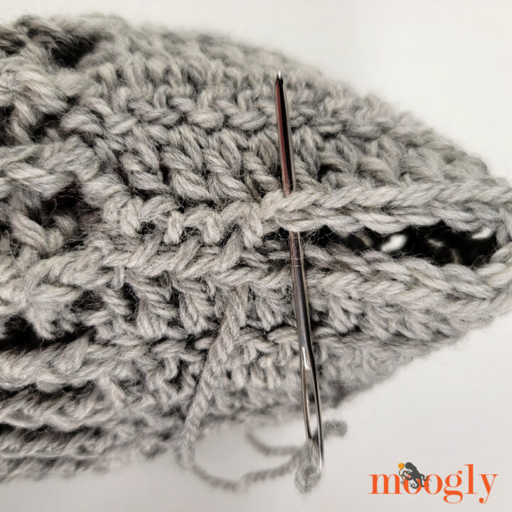 Turn work to stitch around the foot opening. The opening at the back of the heel will be sewn shut later.